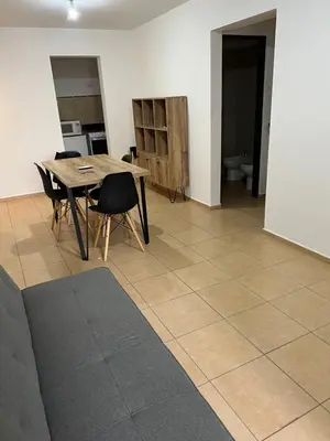a living room with a wooden table and chairs at Castel Di Lucio 6 - Pleno centro Cba - in Cordoba