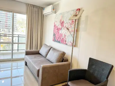 a living room with a couch and a chair at Torre Leonardo Carlos Paz in Villa Carlos Paz