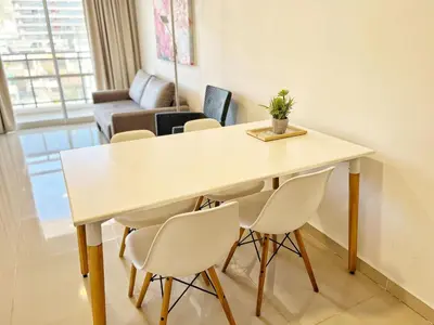 a table and chairs in a room with a couch at Torre Leonardo Carlos Paz in Villa Carlos Paz