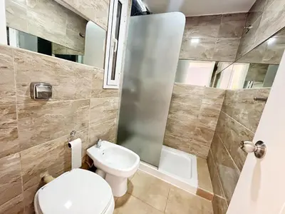 a small bathroom with a toilet and a sink at Torre Leonardo Carlos Paz in Villa Carlos Paz