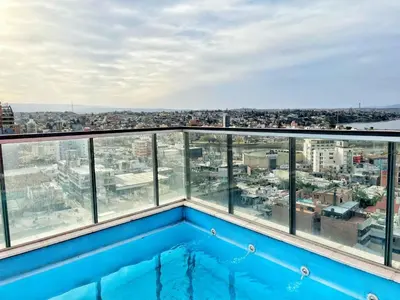 a view from the roof of a building with a swimming pool at Torre Leonardo Carlos Paz in Villa Carlos Paz