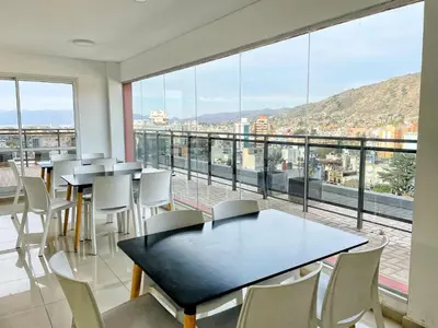 a room with tables and chairs and a large window at Torre Leonardo Carlos Paz in Villa Carlos Paz
