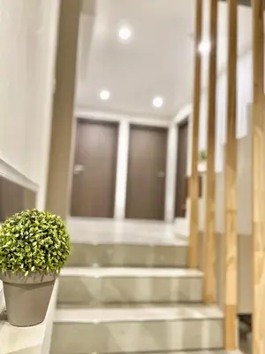 a potted plant sitting in a hallway with stairs at Agrippina in Villa Carlos Paz