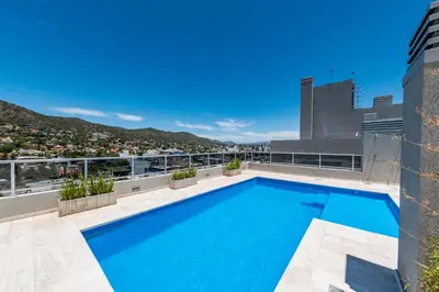 a swimming pool on the roof of a building at Edificio Opera en Villa Carlos Paz - Pileta en Terraza e increíbles vistas in Villa Carlos Paz