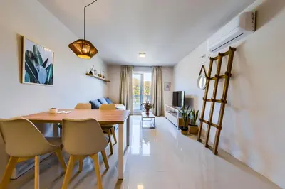 a dining room and living room with a wooden table and chairs at Edificio Opera en Villa Carlos Paz - Pileta en Terraza e increíbles vistas in Villa Carlos Paz