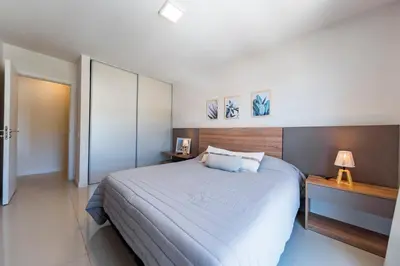 a bedroom with a large bed and two night stands at Edificio Opera en Villa Carlos Paz - Pileta en Terraza e increíbles vistas in Villa Carlos Paz