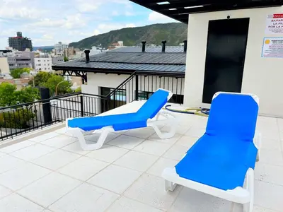 two blue and white chairs on a roof at Don Francisco Apartamentos in Villa Carlos Paz