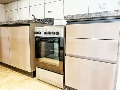 a kitchen with stainless steel appliances and a stove at Don Francisco Apartamentos in Villa Carlos Paz