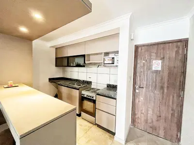 a kitchen with a stove and a counter top at Don Francisco Apartamentos in Villa Carlos Paz