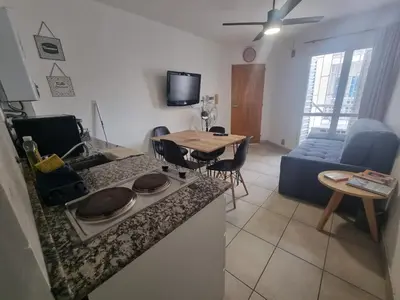 a kitchen and a living room with a table at Departamento en el corazón de Guemes! in Cordoba