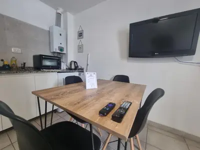 a table with two remote controls sitting on top of it at Departamento en el corazón de Guemes! in Cordoba