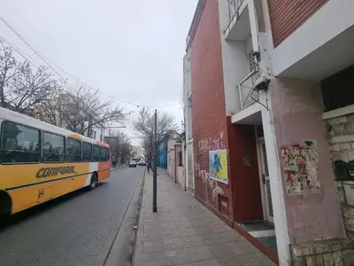 a bus is parked on the side of a street at Departamento en el corazón de Guemes! in Cordoba