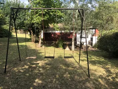 an empty swing set in a yard at La Candelaria in Santa Rosa de Calamuchita