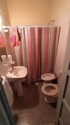 a bathroom with a sink and a toilet and a shower at La Candelaria in Santa Rosa de Calamuchita