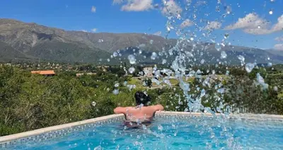 a person in a swimming pool with water splashing at Mirador Merlo in Merlo