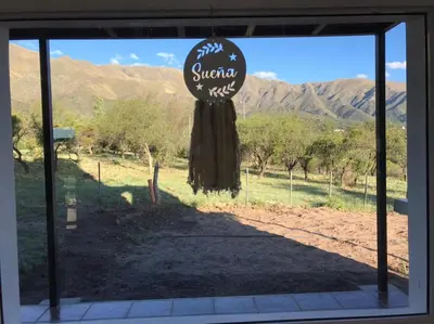 a glass door with a sign in the middle of a yard at Mirador Merlo in Merlo