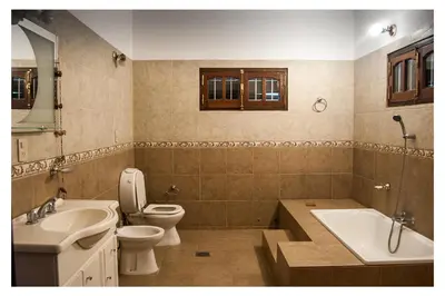 a bathroom with a toilet and a sink and a tub at VILLA BEATRIZ in Villa Anizacate