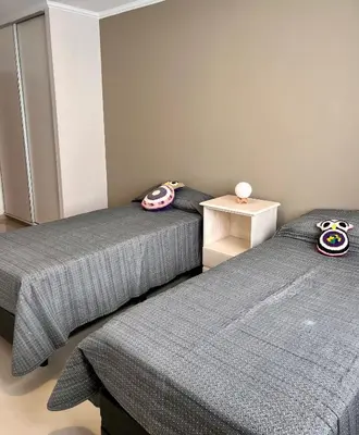 two beds sitting next to each other in a room at Depto Tatiana zona céntrica Carlos Paz in Villa Carlos Paz