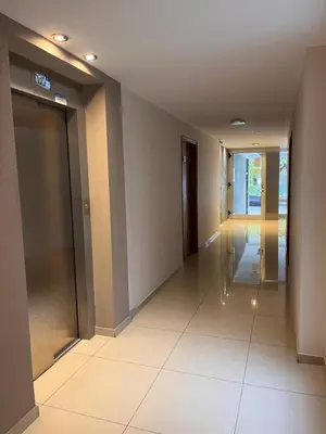 a hallway of a building with elevators and a door at Depto Tatiana zona céntrica Carlos Paz in Villa Carlos Paz