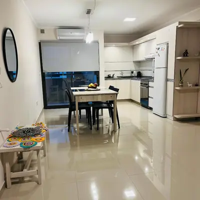a kitchen with a table and chairs in a room at Depto Tatiana zona céntrica Carlos Paz in Villa Carlos Paz