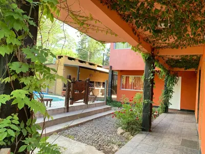 an outside view of a house with a patio at Posada The Gringos in Villa Yacanto