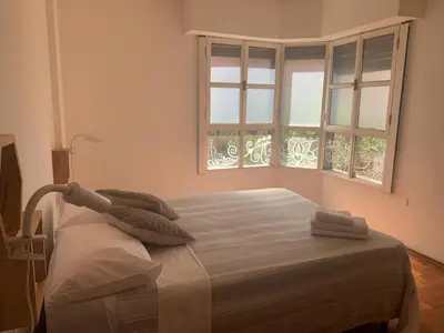 a bedroom with a bed with two pillows and a window at Estancia Nueva Córdoba in Cordoba