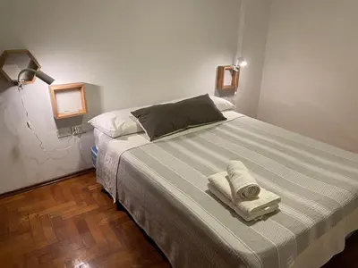 a bedroom with a bed with two towels on it at Estancia Nueva Córdoba in Cordoba