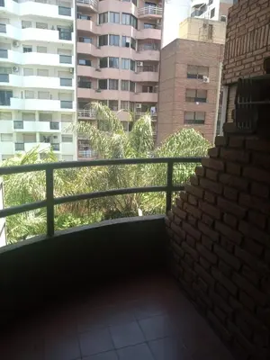 a balcony with a brick wall and some buildings at Estancia Nueva Córdoba in Cordoba