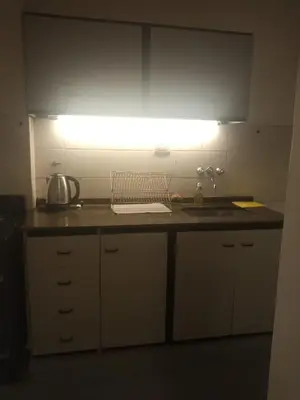 a kitchen with a counter with a sink and a light at Estancia Nueva Córdoba in Cordoba
