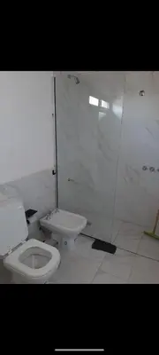 a bathroom with a toilet and a shower stall at Casa Nueva in Villa Rumipal