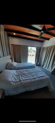 a large bed in a room with a window at Casa Nueva in Villa Rumipal