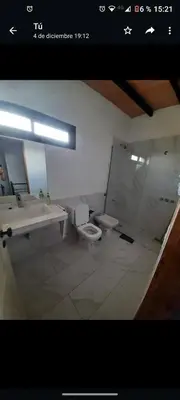 a bathroom with a sink and a toilet and a mirror at Casa Nueva in Villa Rumipal