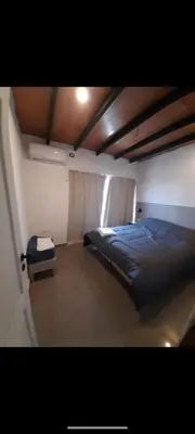 a bedroom with a bed and a window in it at Casa Nueva in Villa Rumipal