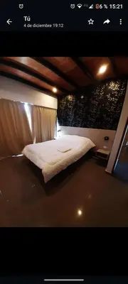 a bedroom with a bed in a room with lights at Casa Nueva in Villa Rumipal