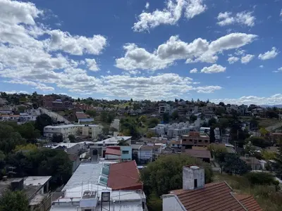 a view of a city under a cloudy sky at DEPARTAMENTO ROCA in Villa Carlos Paz