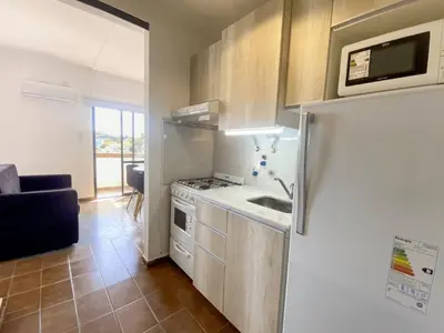 a kitchen with a refrigerator and a sink at DEPARTAMENTO ROCA in Villa Carlos Paz