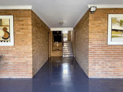 a brick hallway with a brick wall and a stairway at DEPARTAMENTO ROCA in Villa Carlos Paz