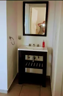 a bathroom with a sink and a mirror at Cabañas Teodoro in Tanti