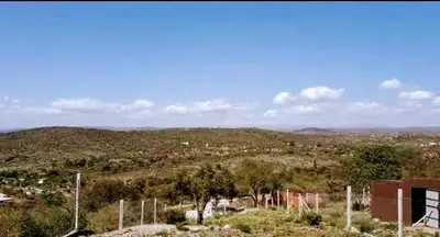 a view of a field with trees and a city at Cabañas Teodoro in Tanti