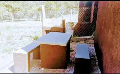 a group of benches sitting next to a building at Cabañas Teodoro in Tanti