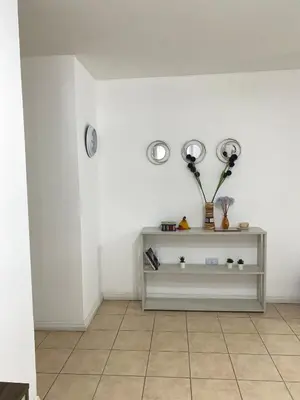 a room with a shelf with two clocks on the wall at Departamento en Nueva Cordoba Centro Bv Illia in Cordoba