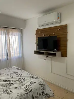 a bedroom with a bed and a flat screen tv at Departamento en Nueva Cordoba Centro Bv Illia in Cordoba