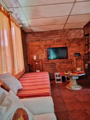 a room with two beds and a tv and a table at Casita serrana in Cassaffousth