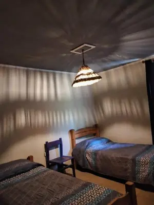 a bedroom with two beds and a ceiling at Casita serrana in Cassaffousth