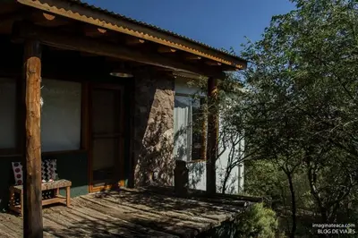 a house with a bench on the porch of it at El Observador del Tiempo in San Javier