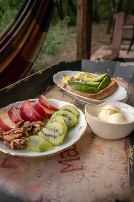 two plates of food on a table with fruit and vegetables at El Observador del Tiempo in San Javier