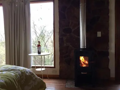 a bedroom with a brick wall with a stove at El Observador del Tiempo in San Javier