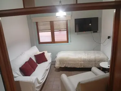 a living room with a couch and a bed at Departamento Santa Rosa in Cordoba