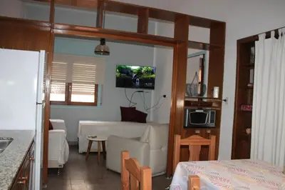 a living room with a kitchen and a living room with a couch at Departamento Santa Rosa in Cordoba