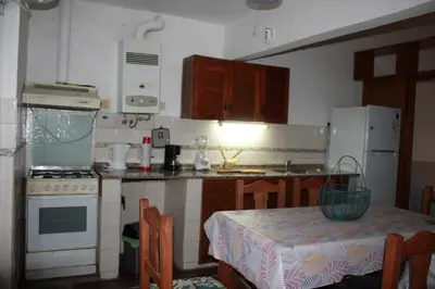 a kitchen with a table and a kitchen with a stove at Departamento Santa Rosa in Cordoba